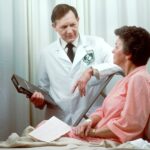 man in white button up shirt holding black tablet computer